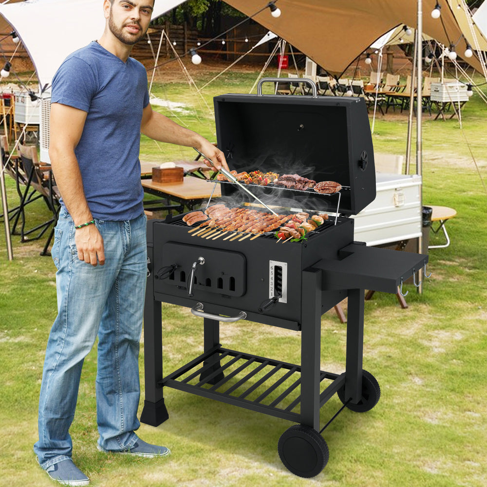 24-inch barrel charcoal grill with 544 sq.in cooking area, two folding side tables, and adjustable air vents for.