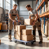 Two workers using a 660 pounds folding platform cart dolly hand truck to transport boxes in a warehouse setting.