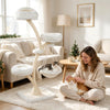 Multi-level beige cat tower features a top perch, two soft beds, a hammock, and sisal posts for climbing and lounging.