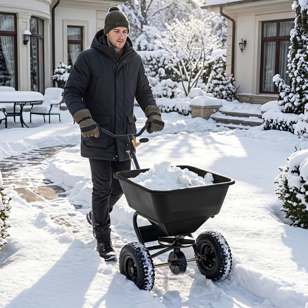 Walk-behind broadcast spreader with 66 lbs capacity, 13-inch all-terrain tires, ideal for efficient snow and lawn spreading.