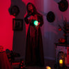 Life-sized standing witch animatronic with glowing eyes and magical ball, perfect for Halloween decor and spooky.