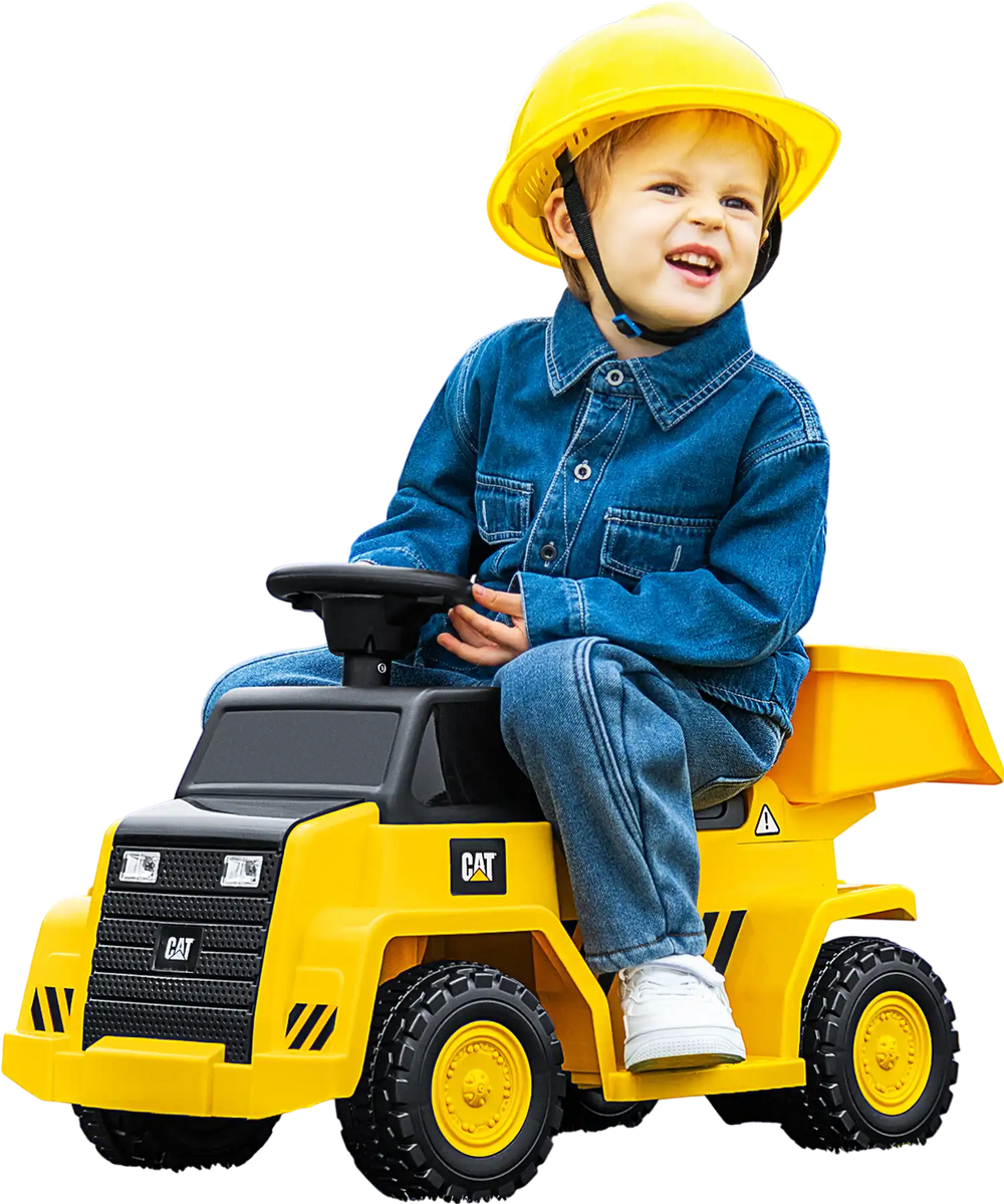Child riding a yellow 6V electric Caterpillar construction vehicle with a detachable dump bed, designed for fun and.