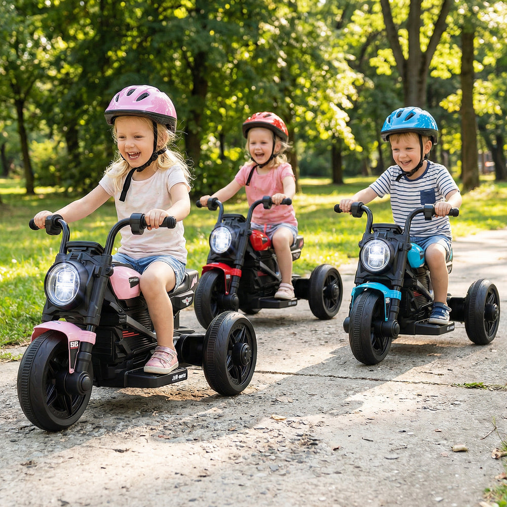 Three kids riding 6V electric motorcycles in a park, featuring LED headlights and colorful designs for toddlers.
