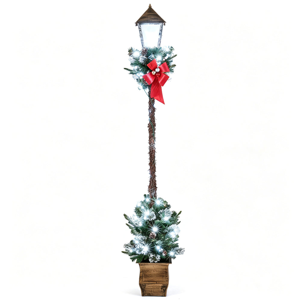 6.1 feet pre-lit Christmas street lamp features snow-flocked greenery, red bow, and LED lights for festive decoration.
