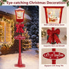 6.1 ft red musical Christmas streetlight with LED lights features a Santa scene, bow, and wreath for festive outdoor decor.