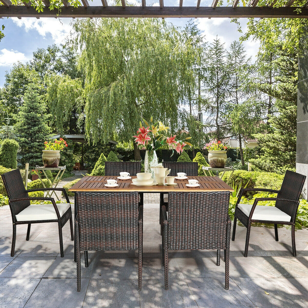 7-piece patio dining set featuring a spacious acacia wood table and cushioned armchairs, perfect for outdoor gatherings.
