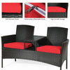 Modern patio conversation set featuring a built-in coffee table, red cushions, and durable rattan for outdoor comfort.