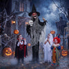 Life-sized Halloween animatronic witch with flickering eyes and skull, perfect for spooky trick-or-treat displays.