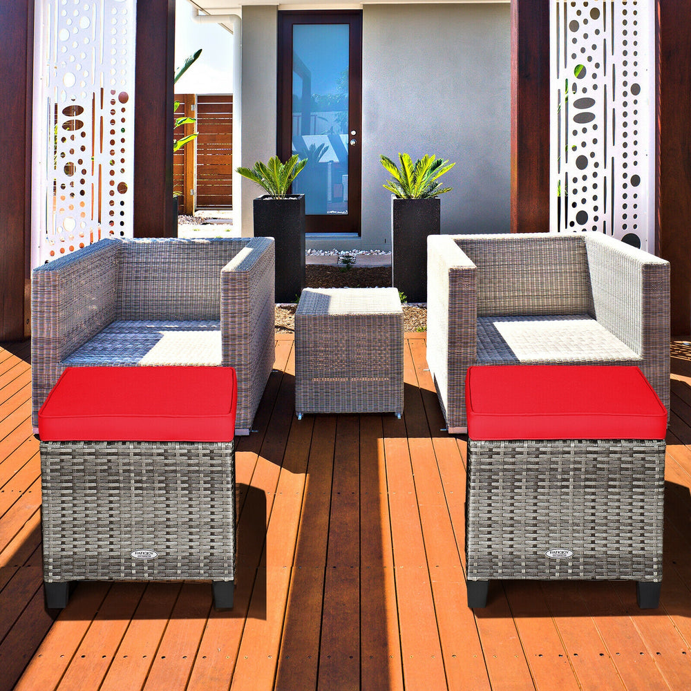 Two-piece patio rattan ottomans with removable red cushions, perfect for outdoor use in gardens or poolside settings.