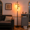 Retro floor lamp with three amber glass shades, stable iron base, perfect for living room or office lighting.