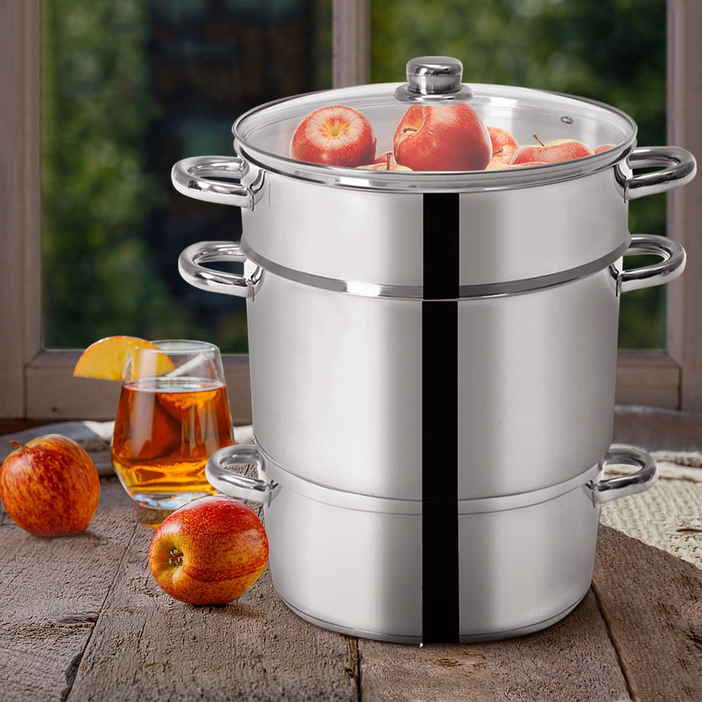 11-quart stainless steel fruit juicer steamer set on a wooden table with apples, perfect for juice and nectar.