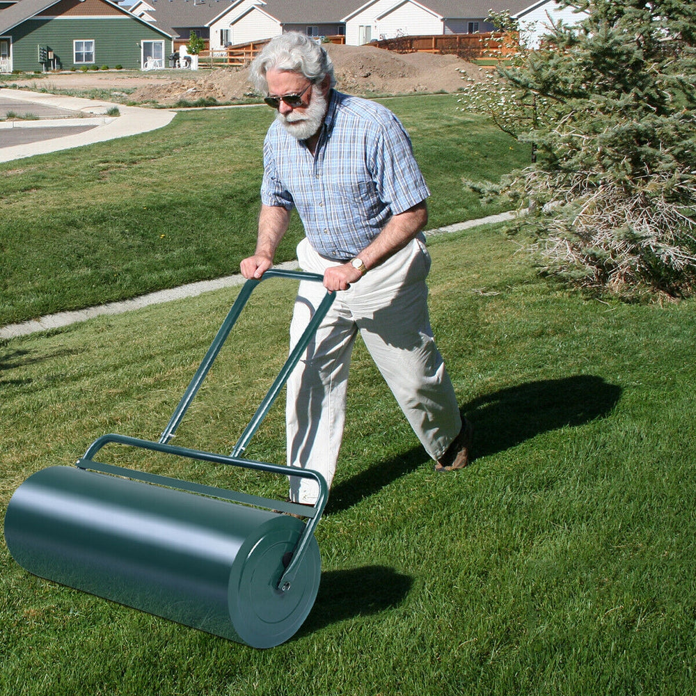 Metal push lawn roller with a green finish, 24 x 13 inches, ideal for leveling soil and packing down seed.