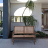 Brown 48-inch swing glider loveseat with curved backrest and armrests, perfect for outdoor patios and gardens.