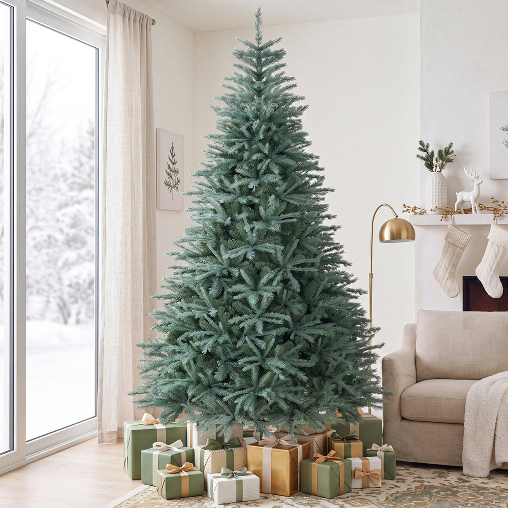 Blue-green artificial Christmas tree with 775 lush branch tips, perfect for home or office holiday decor.