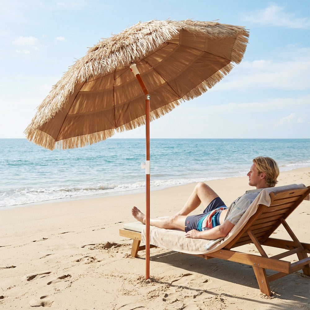 Thatched beach umbrella with tilt adjustment and carrying bag, perfect for sun protection at the beach or garden.