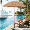 Thatched Tiki umbrella with 40° tilt adjustment, perfect for beach or garden use, showcasing a natural look by the pool.