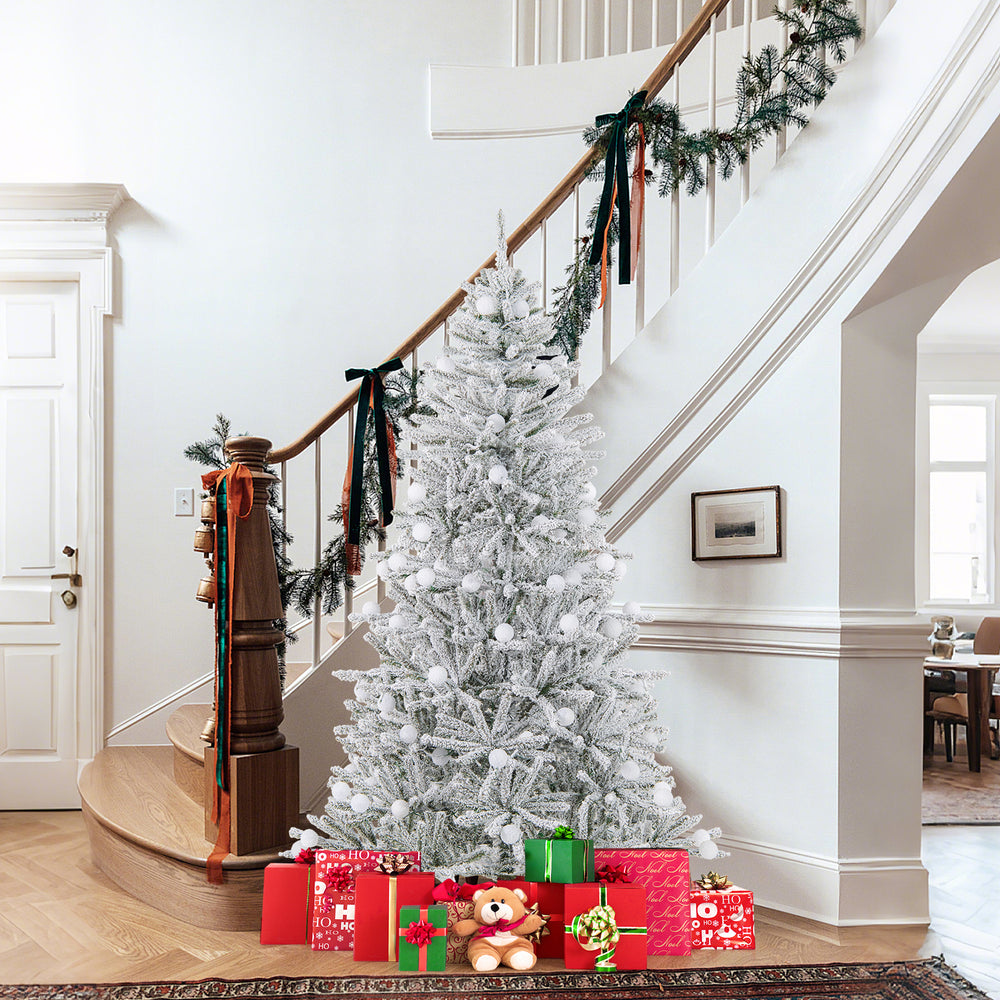 Snow-flocked 6 feet artificial Christmas tree with 81 pre-lit sphere lights and gifts, perfect for holiday decor.