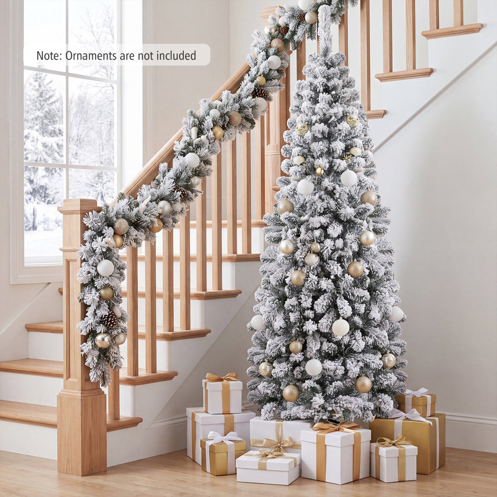 Snow-flocked 6 feet unlit pencil Christmas tree with 500 branch tips, perfect for small corners during holiday celebrations.