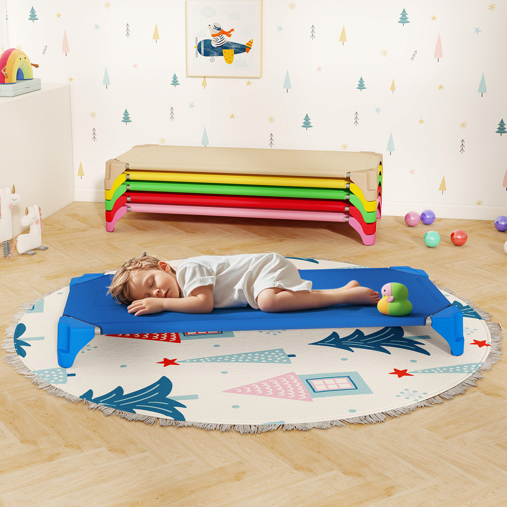 Portable stackable daycare cot in blue with a child sleeping, ideal for home or kindergarten rest time.