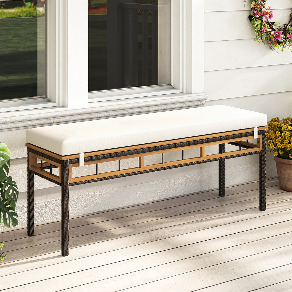 Backless wicker patio bench for 2 people with white acacia wood seat and removable cushion, ideal for outdoor dining.
