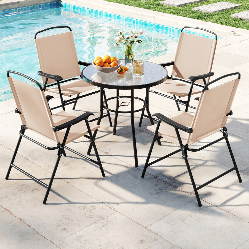 Patio dining set featuring a ripped tempered glass tabletop and four folding armchairs in beige for outdoor relaxation.
