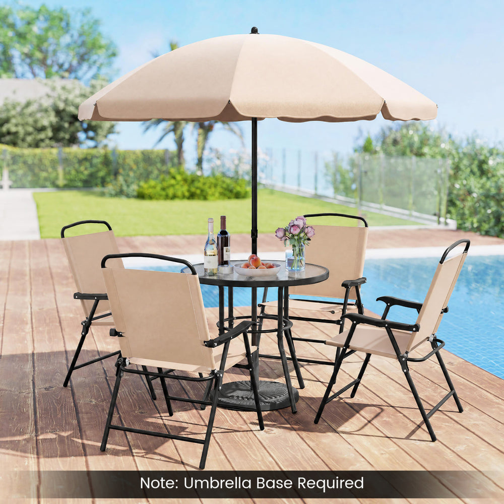 Patio dining set featuring a ripped tempered glass tabletop, beige fabric, and four folding armchairs for outdoor comfort.