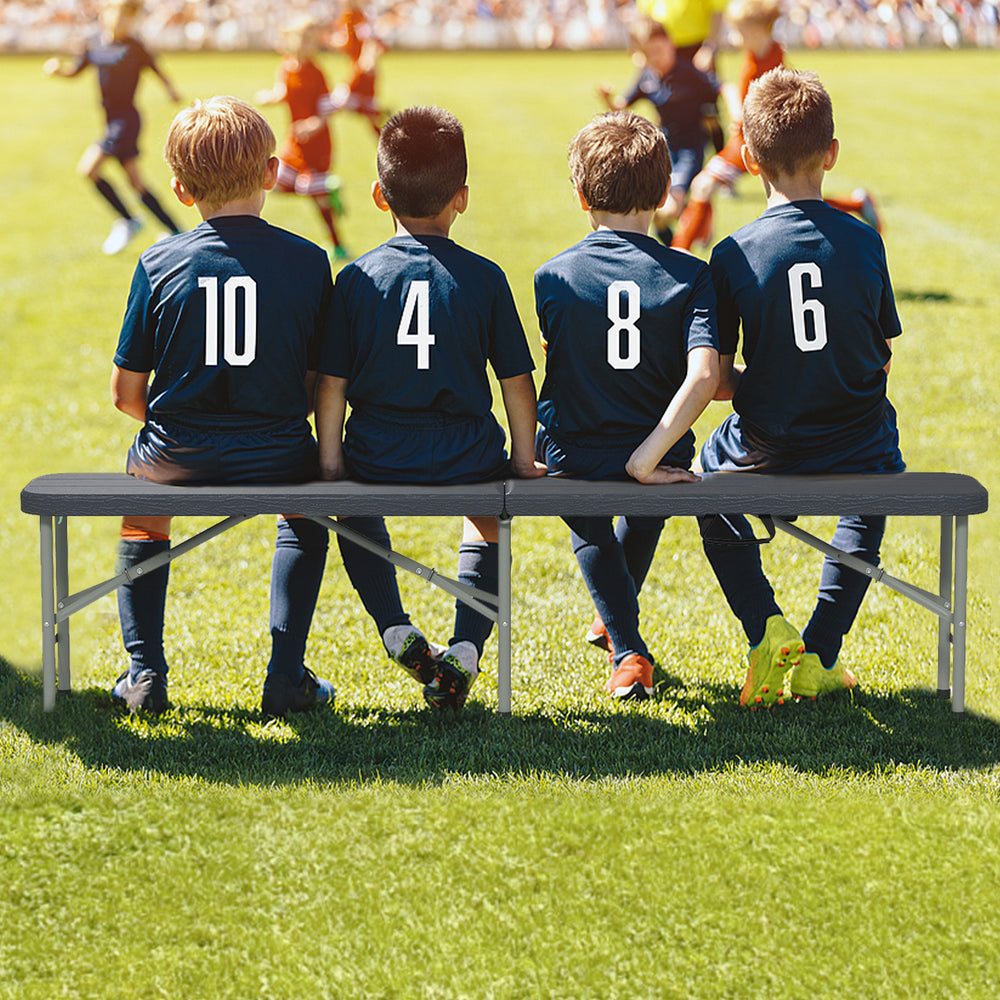 Gray 6 feet folding HDPE bench with wood-like texture, accommodating up to 4 people for outdoor events like soccer.