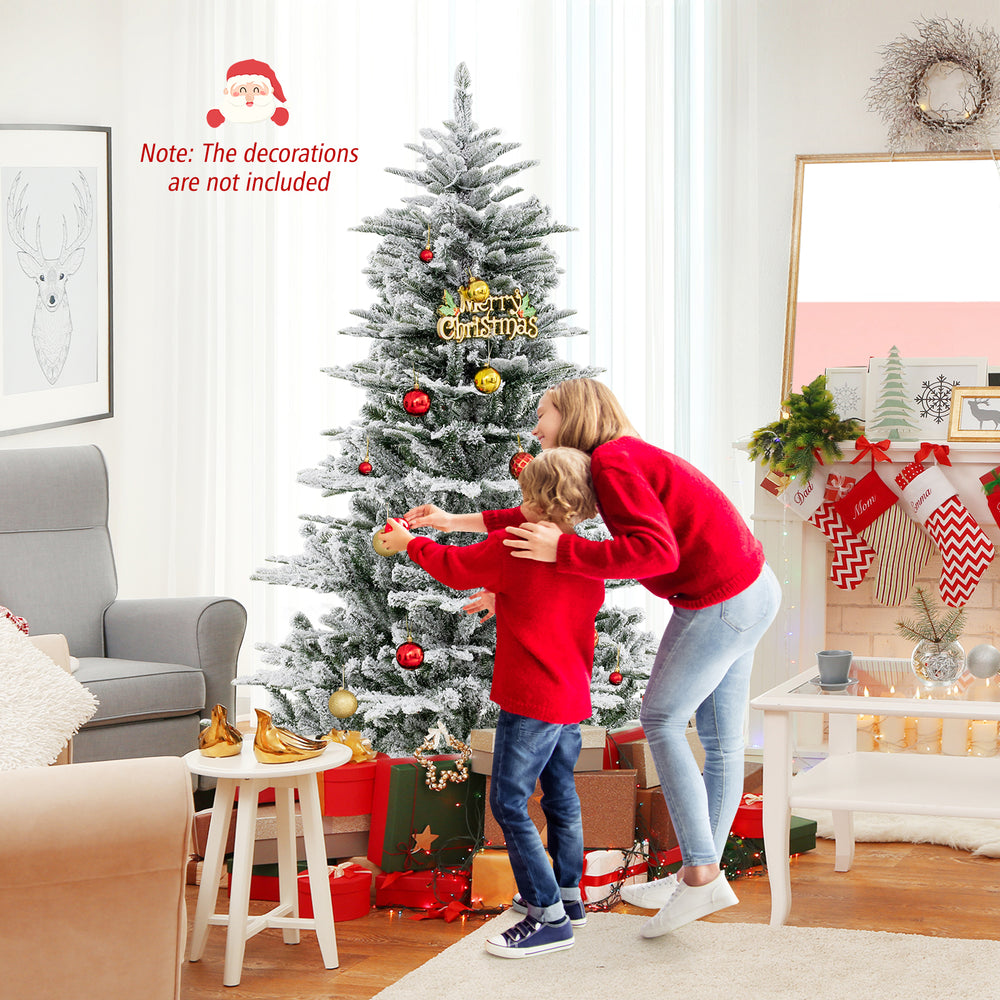 Snow flocked 6 feet artificial Christmas tree with cool white LED lights, perfect for festive home decoration.
