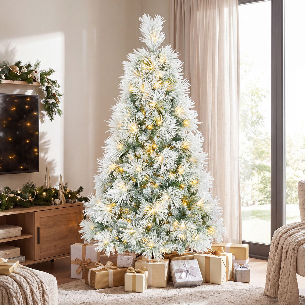 6 ft flocked pine Christmas tree glows with pre-lit LED lights and warm white accents in a festive living room.