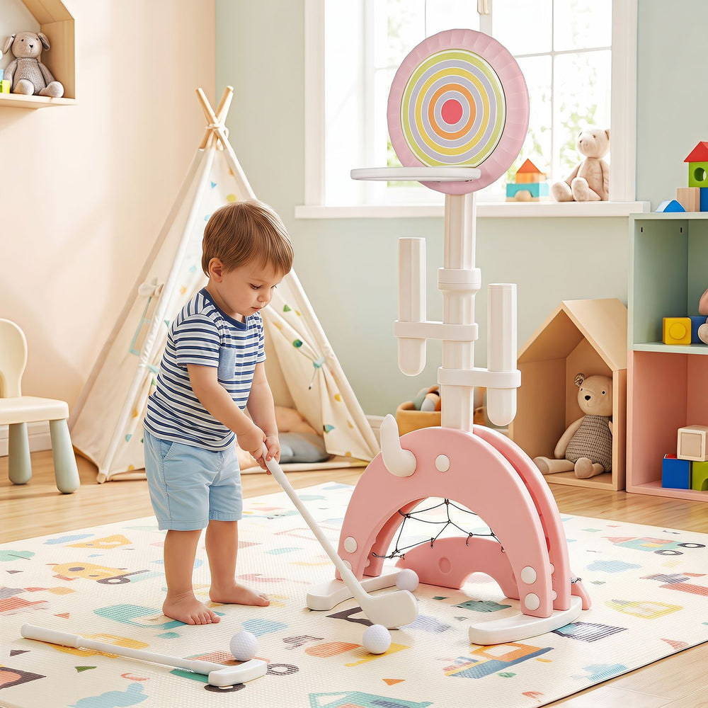Toddler playing with the pink 6-in-1 basketball hoop, featuring adjustable height and multiple sports options for indoor fun.