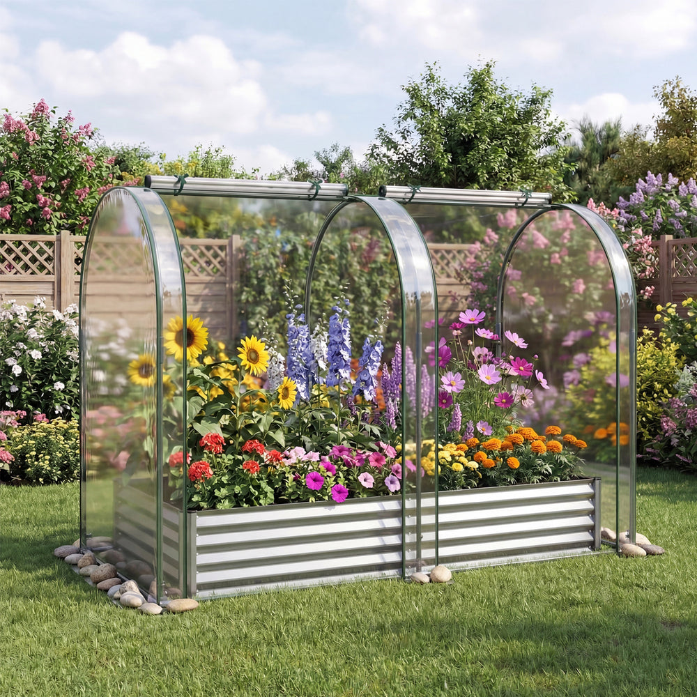 Galvanized raised garden bed with greenhouse cover, featuring vibrant flowers and a protective design for year-round.