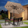 Tan 7.5 feet solar-powered patio umbrella with LED lights, crank handle, and push button tilt for outdoor shade.