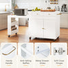 Kitchen island with extendable dining table, white finish, ample storage, and smooth-rolling wheels for flexible placement.