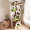Multi-level cat tree featuring a large condo, elevated perch, and dangling pompoms for indoor cat play and relaxation.