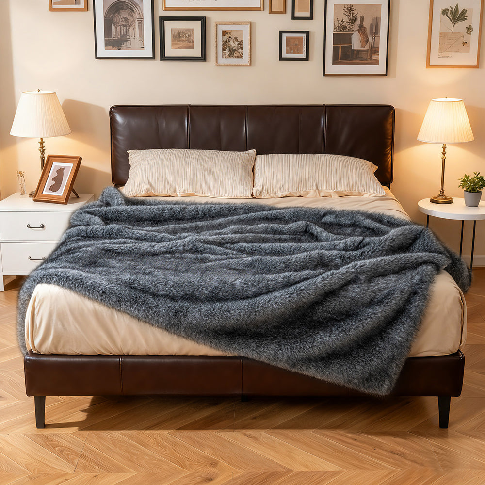 Gray 740GSM soft plush fuzzy faux wolf fur blanket draped over a bed, ideal for warmth and comfort.