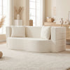 Beige 75.5-inch folding sofa bed with curved backrest, two pillows, and teddy fleece cover for versatile comfort.