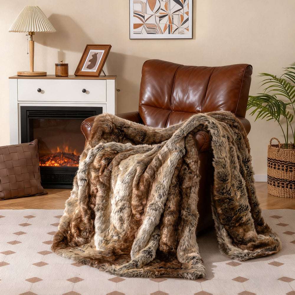 Soft plush fuzzy luxury faux raccoon fur blanket draped over a brown armchair, ideal for cozying up on sofas or beds.