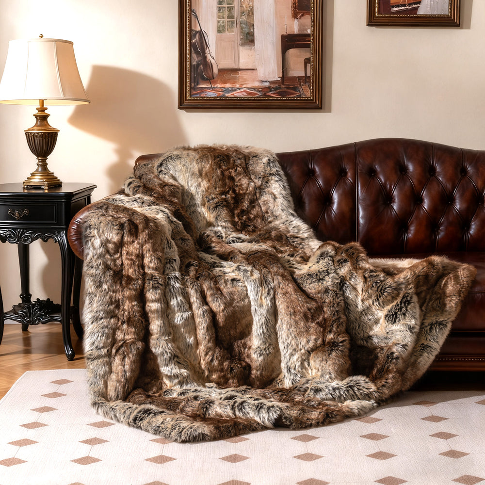 Luxurious 760GSM faux raccoon fur blanket draped over a sofa, featuring a soft texture for cozy warmth and style.