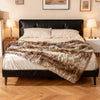 Soft plush fuzzy luxury faux raccoon fur blanket on a bed, featuring a double-sided design for warmth and comfort.