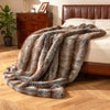 Soft plush fuzzy luxury faux fox fur blanket in brown draped over a bed, ideal for sofas and cozy relaxation.