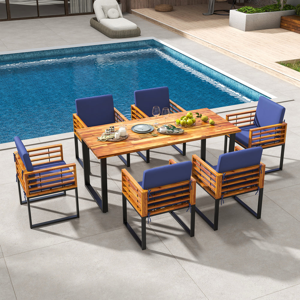 7-piece patio dining set featuring acacia wood table and navy cushioned chairs, perfect for poolside gatherings.