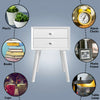 White wooden nightstand with two smooth sliding drawers, ideal for showcasing decor and providing stylish storage.