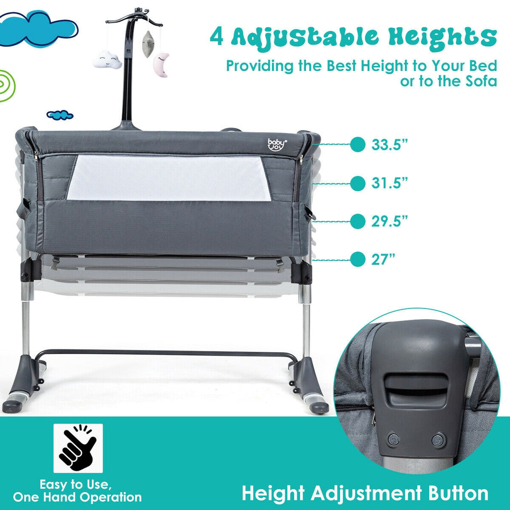 Height adjustable baby side crib in dark gray with music box and toys, perfect for bedside care and co-sleeping.