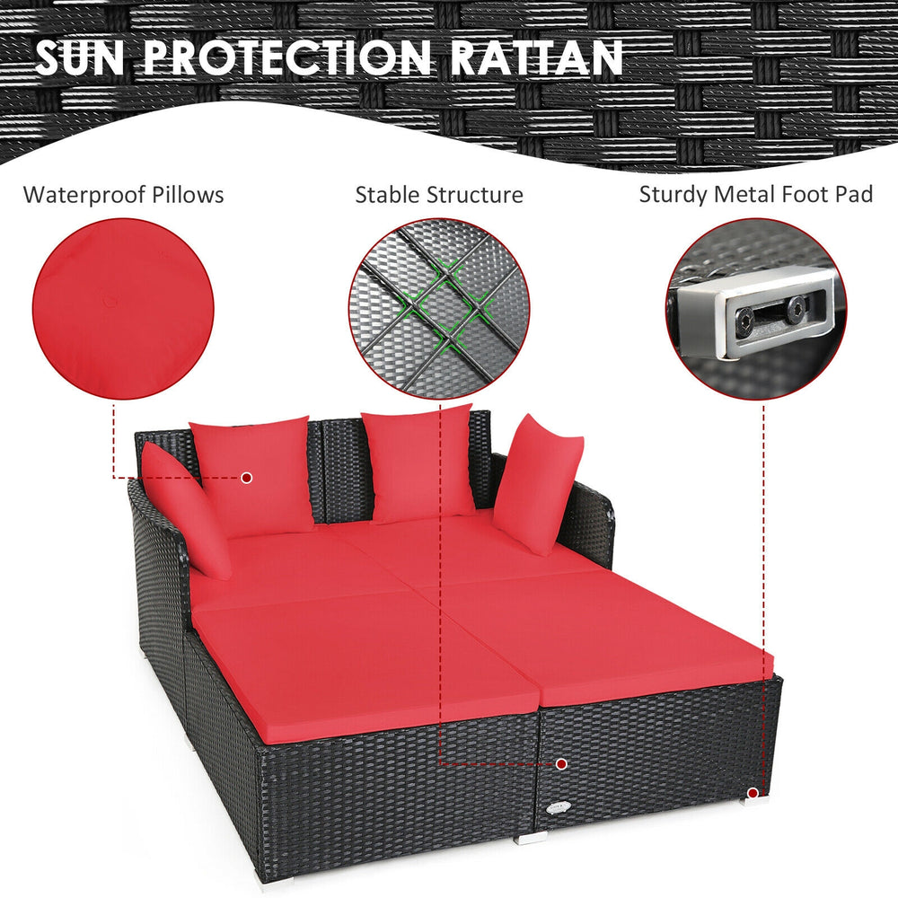Spacious outdoor rattan daybed with red upholstered cushions, featuring a sturdy structure and waterproof pillows for.