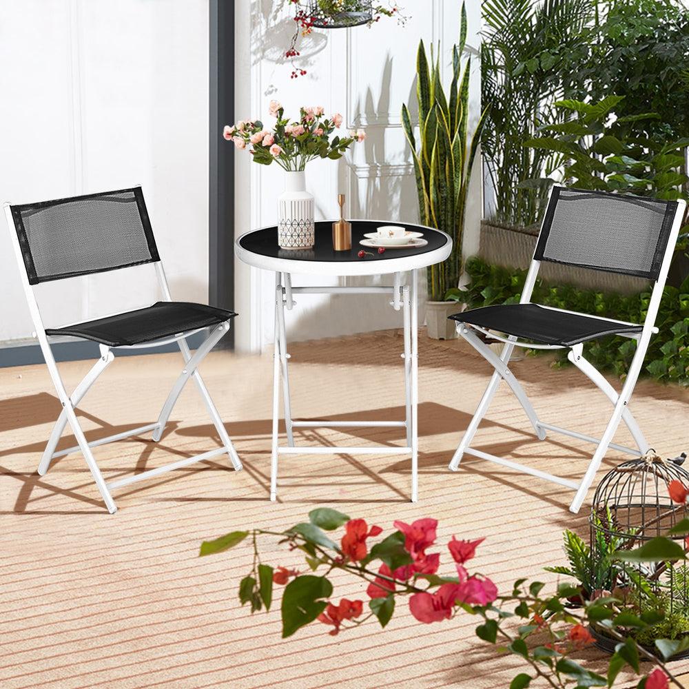 Folding bistro set featuring two black chairs and a round glass-top table, perfect for outdoor patio or balcony use.
