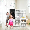 Kids play with a wooden kitchen set featuring a refrigerator, stove, and sink, enhancing creativity and role-play.