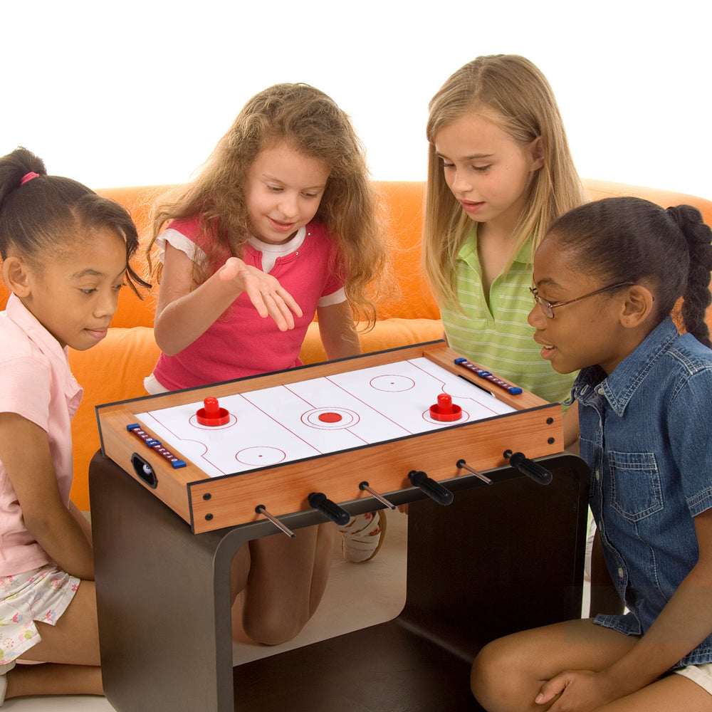 Children playing with the 2-in-1 Indoor/Outdoor Air Hockey Foosball Game Table, featuring rotating surfaces for.