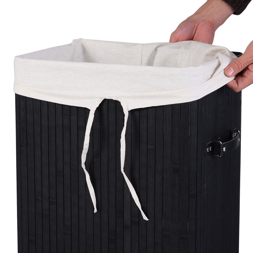 Black bamboo laundry hamper with detachable cotton inner pocket and sturdy lid for easy transport and storage.