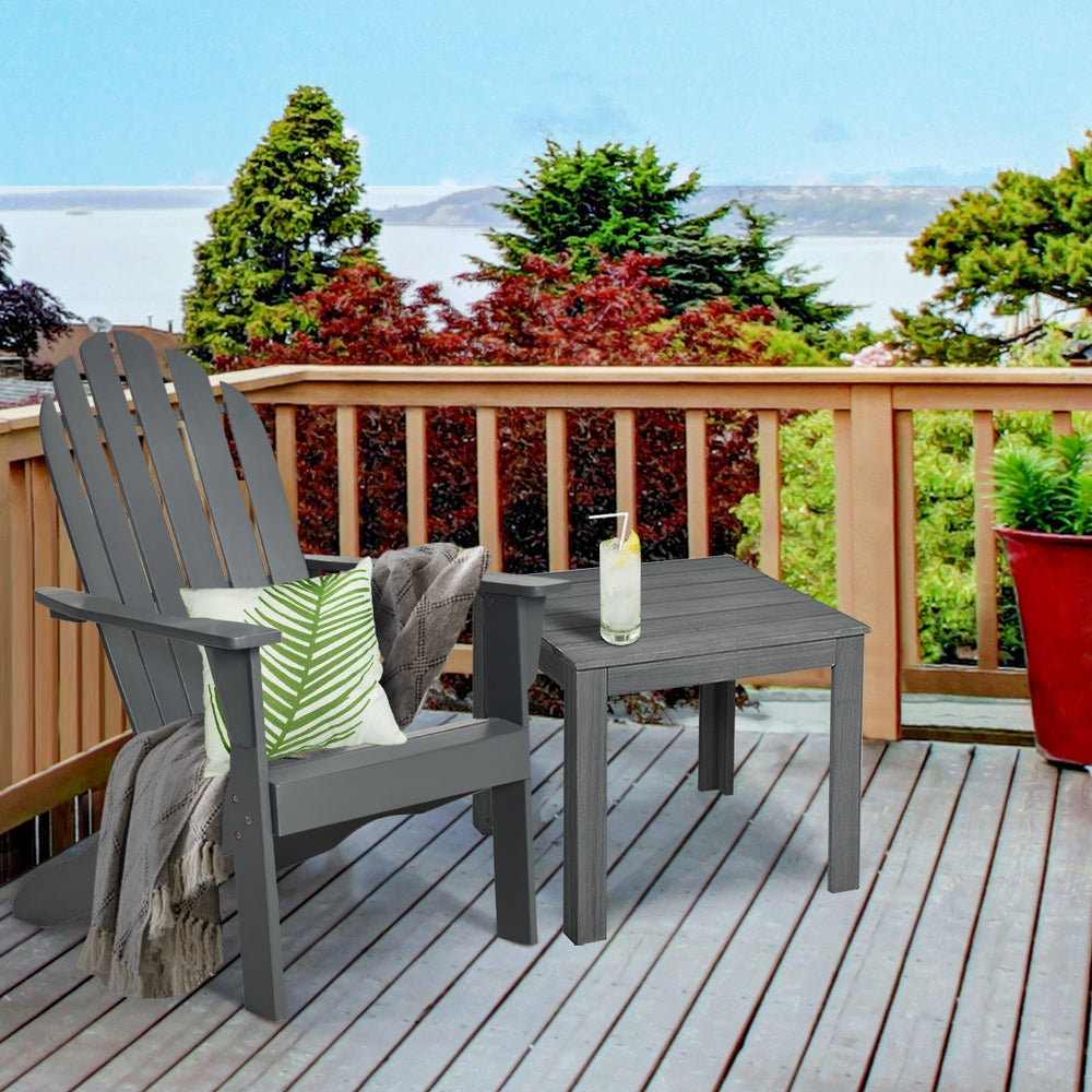 Gray acacia wood Adirondack chair with ergonomic design, perfect for outdoor relaxation on a patio or deck.