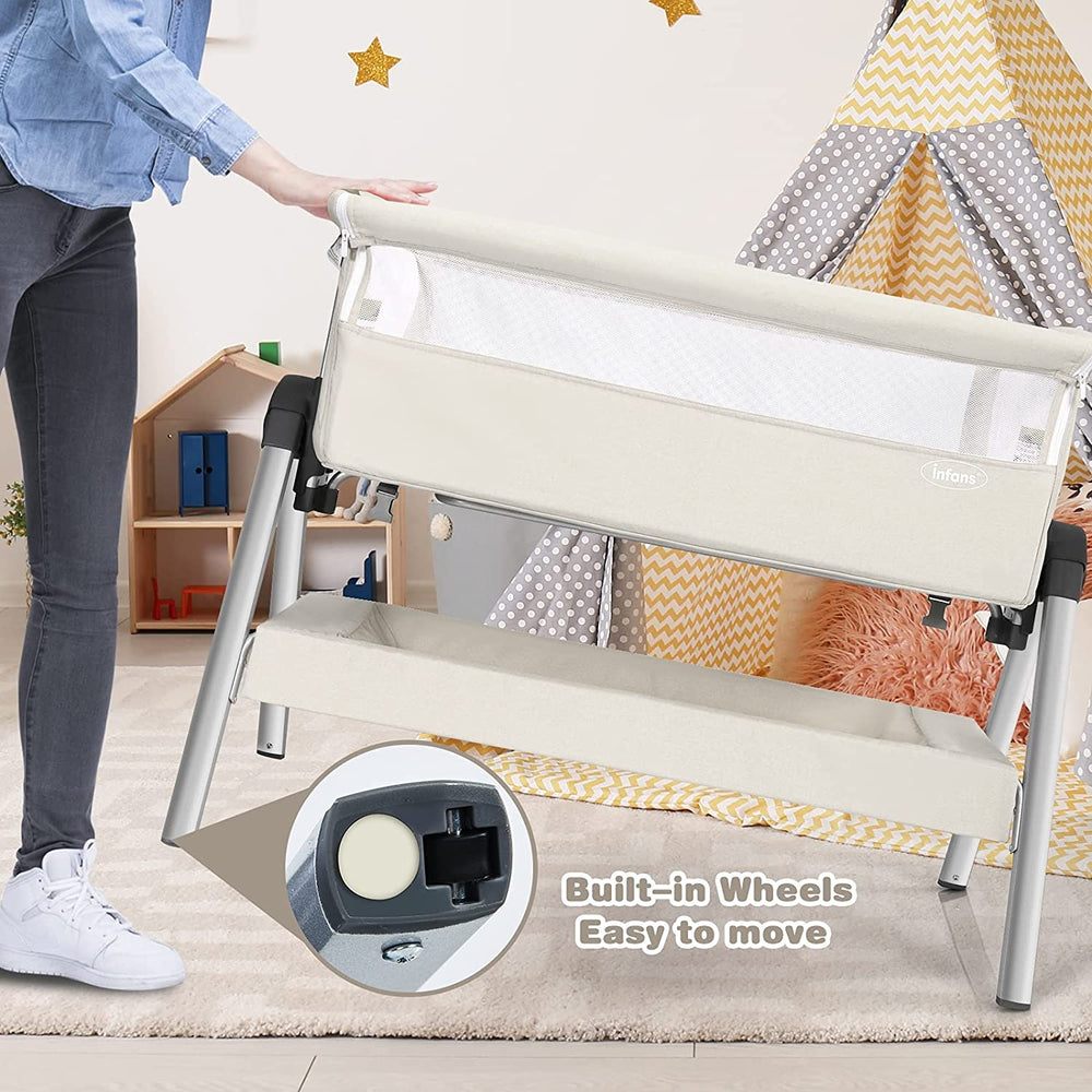 Portable baby bedside sleeper with adjustable height, angle, and built-in wheels for easy mobility and comfort.